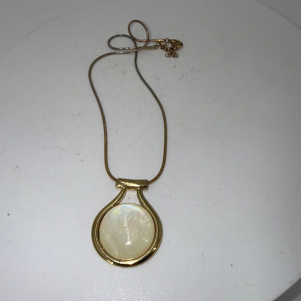 Vtg Kenneth Cole gold-toned pendant w/ round white cabochon like mother-of-pearl